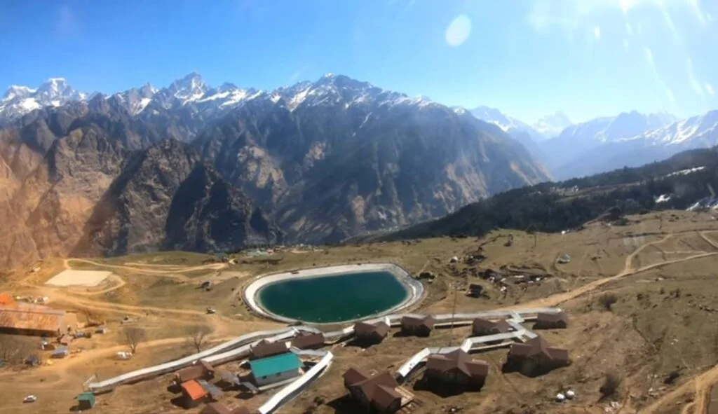 The beautiful view of mountains with an Artificial Chenab lake and some houses